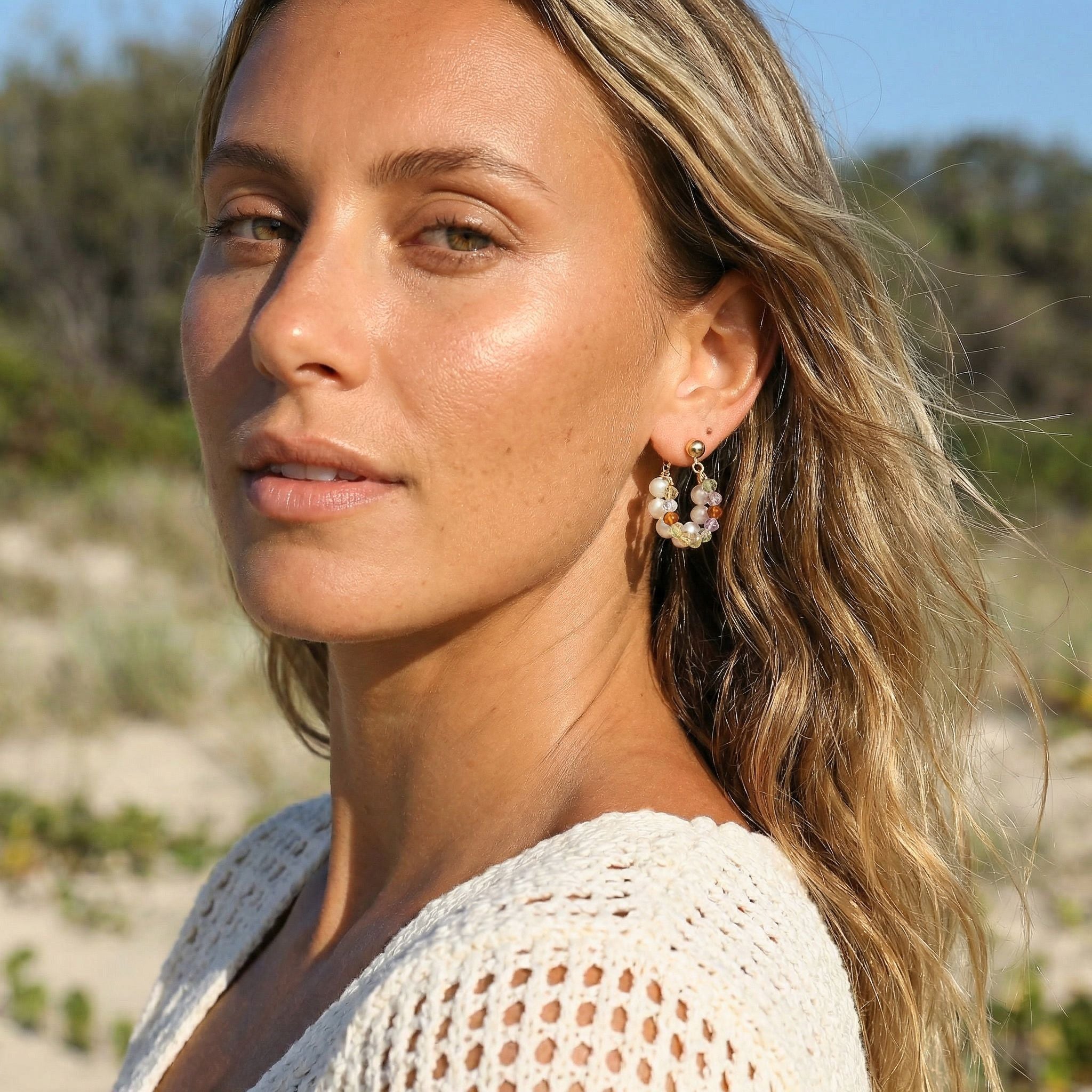 Woman wearing earrings with a natural background