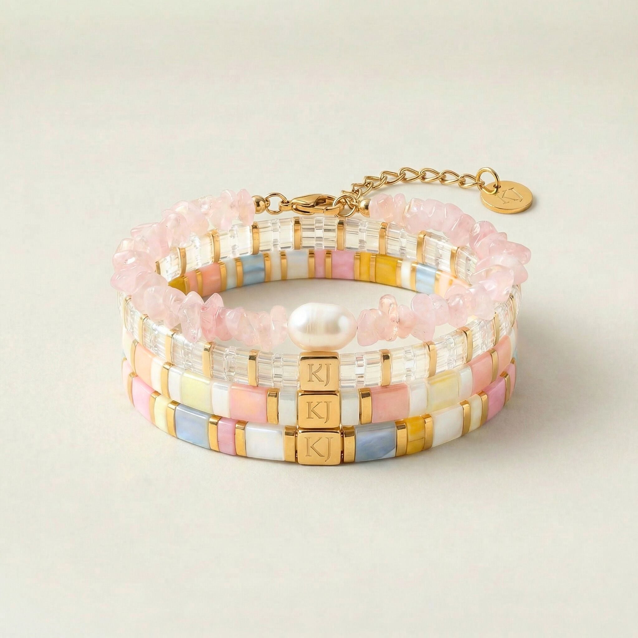 Stack of colorful beaded bracelets on a light background
