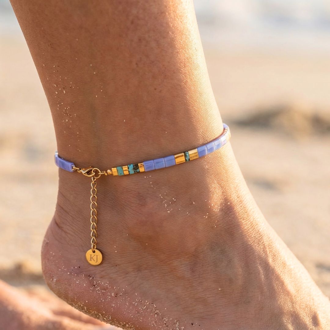 Anchored bracelet on a person's ankle with a beach background