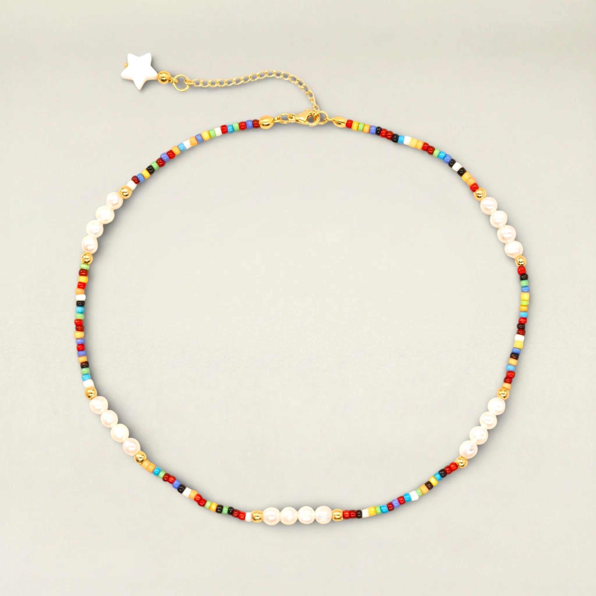 Necklace with colorful beads and white pearls on a light gray background
