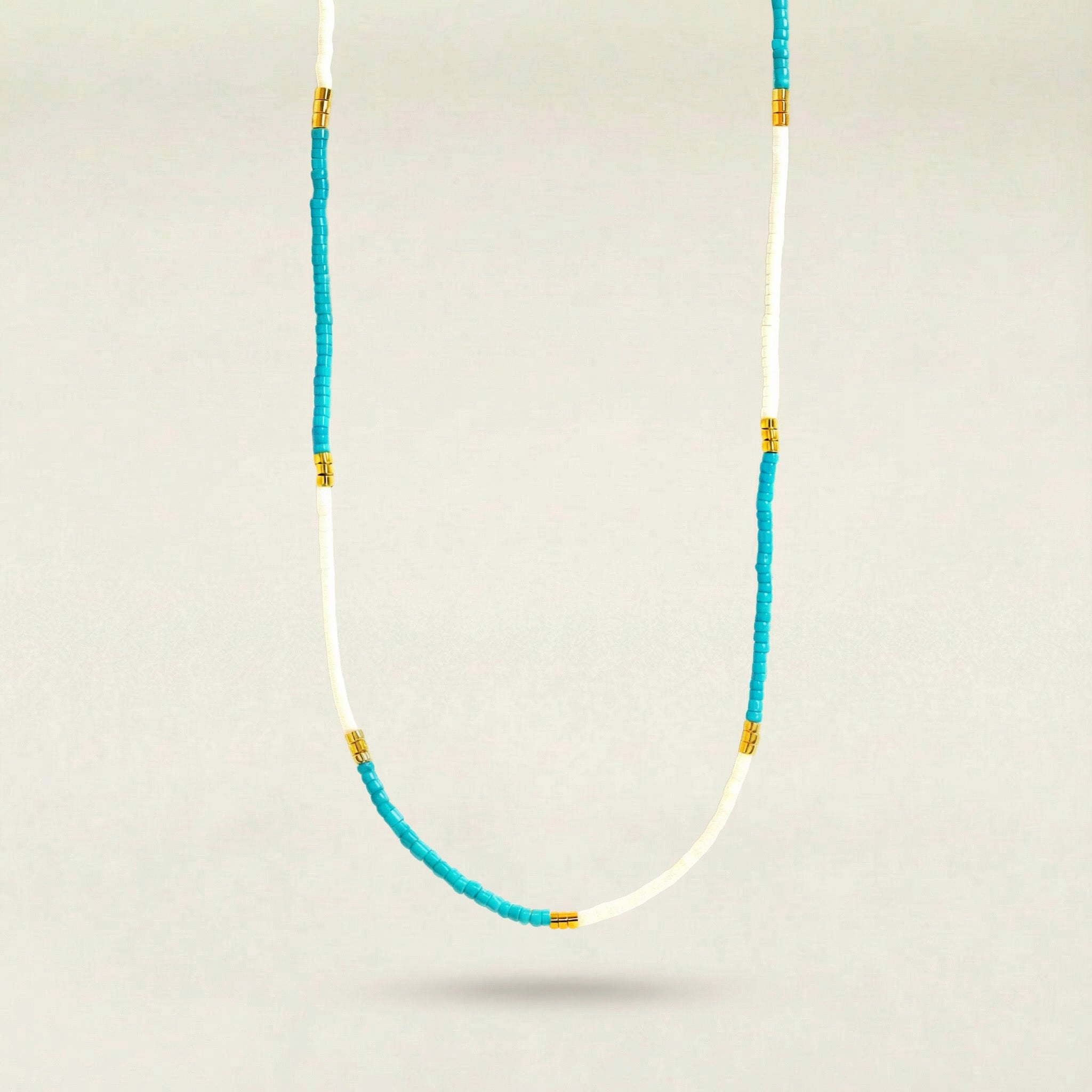 Necklace with blue and gold beads on a white background
