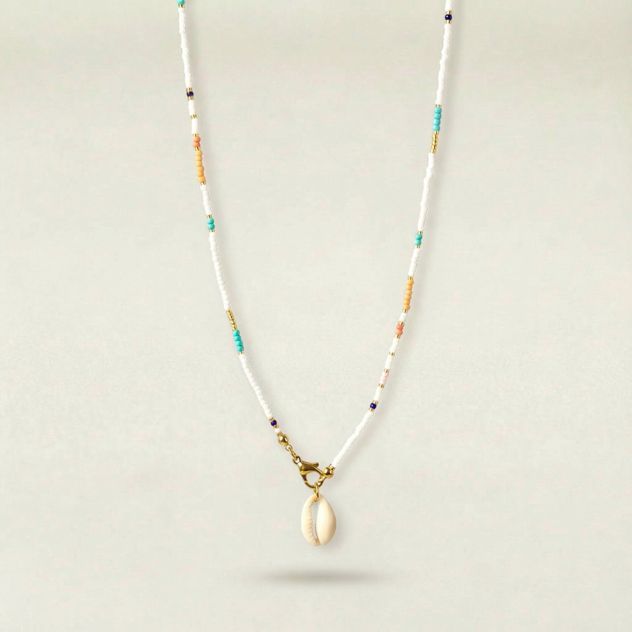 Necklace with a shell pendant on a light gray background