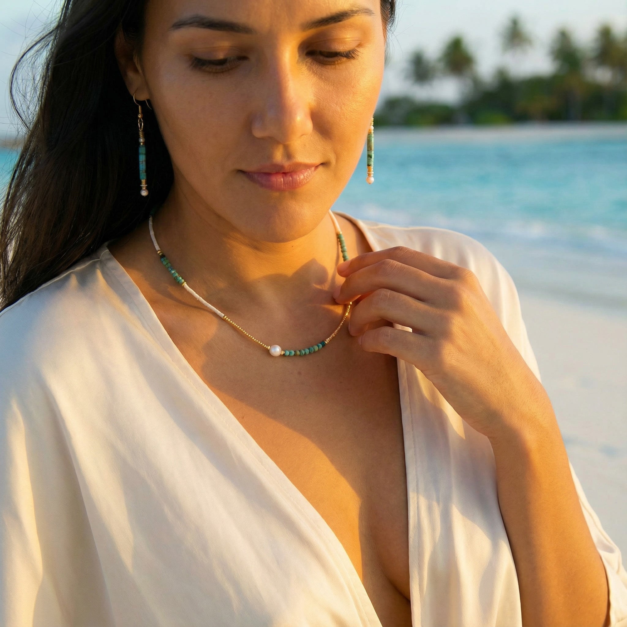 Woman on a beach wearing a necklace with a blurred background