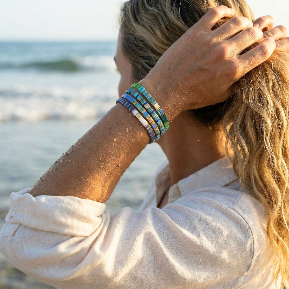Person wearing a colorful bracelet on a beach