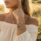 Woman with a tattoo on her wrist in a natural setting