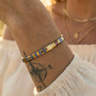 Close-up of a wrist wearing a colorful bracelet with a blurred background