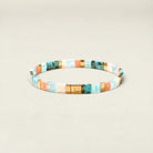 Multicolored beaded bracelet on a beige background