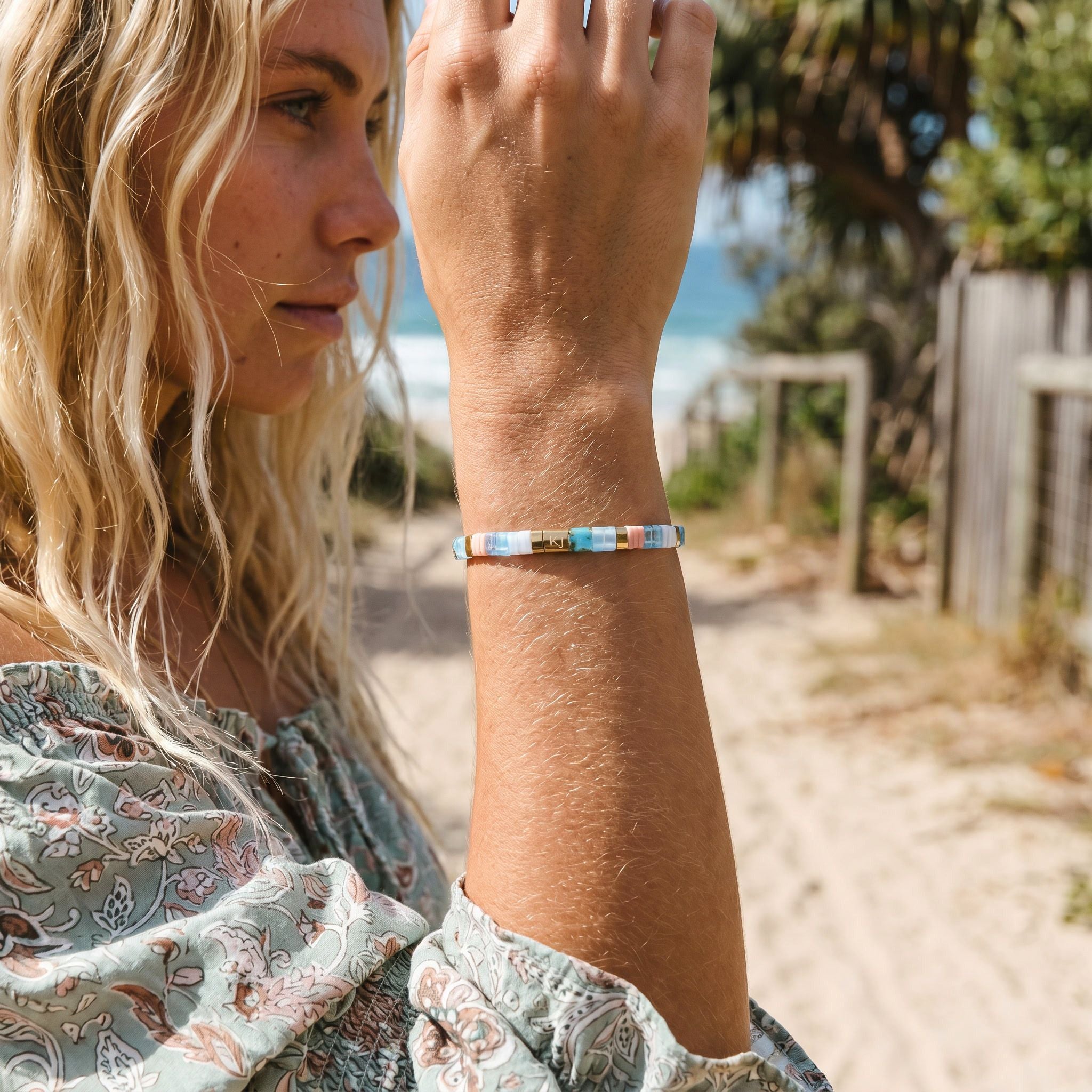 Woman on a beach wearing a colorful bracelet