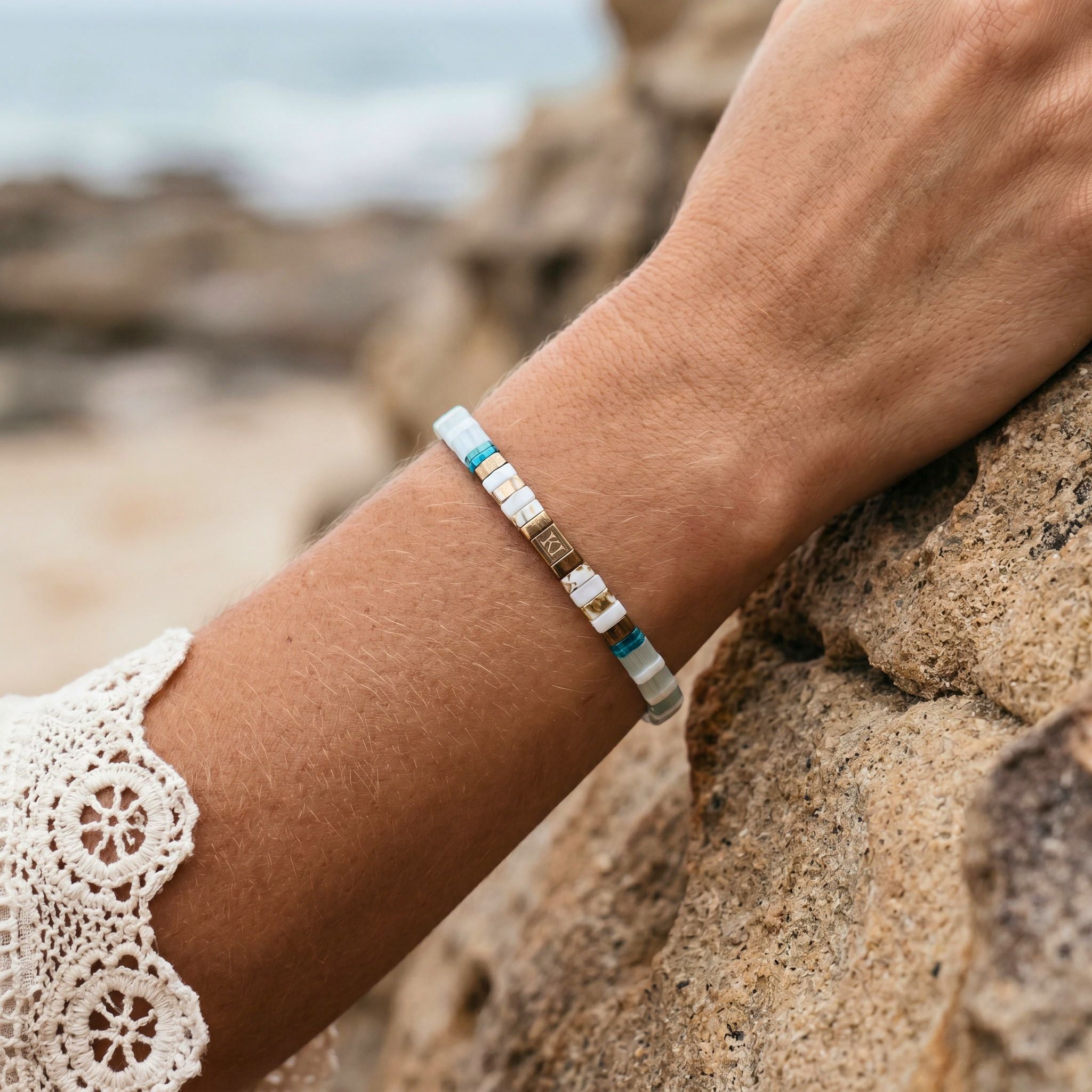Bracelet with small beads on a wrist against a natural background
