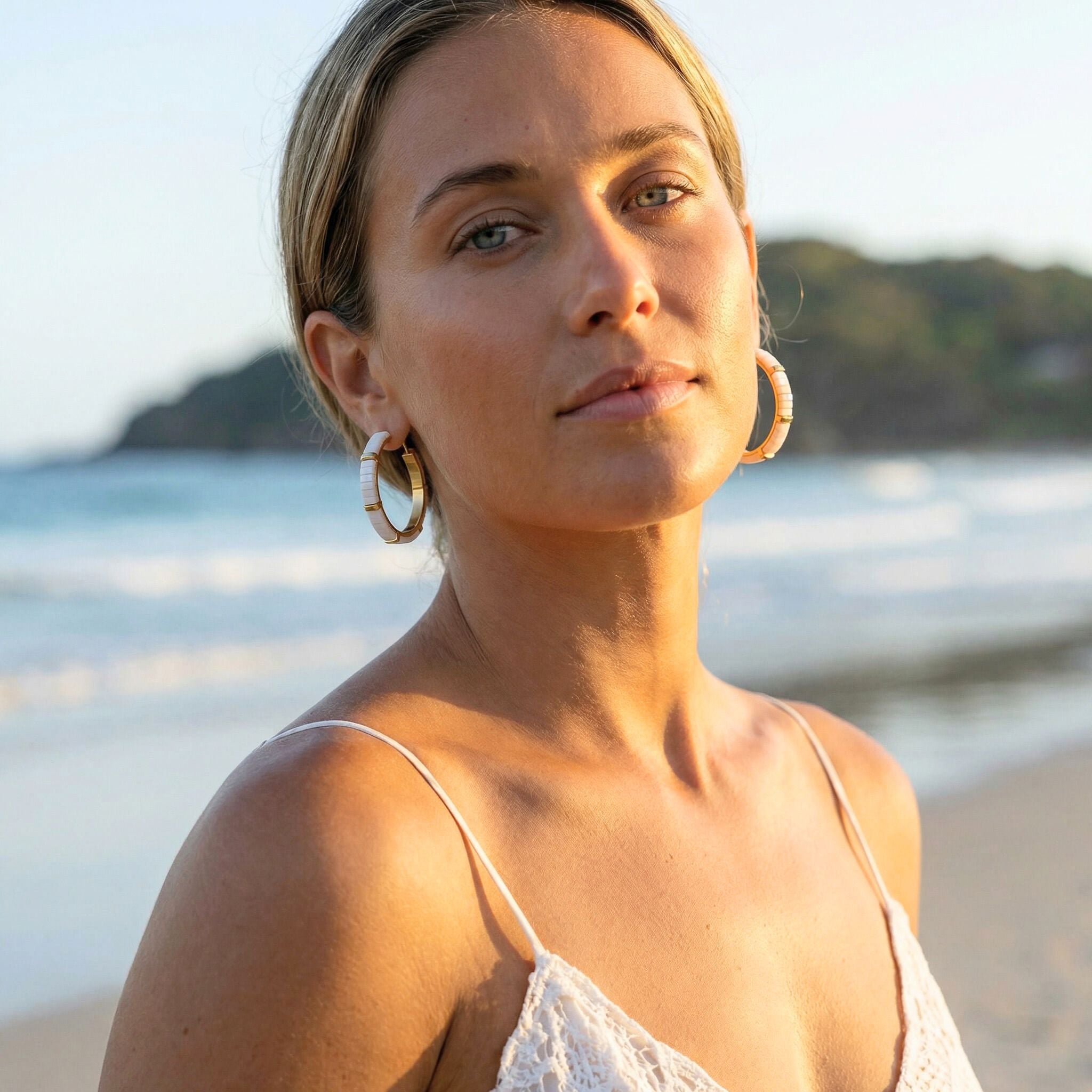 Woman on a beach with ocean and sky in the background