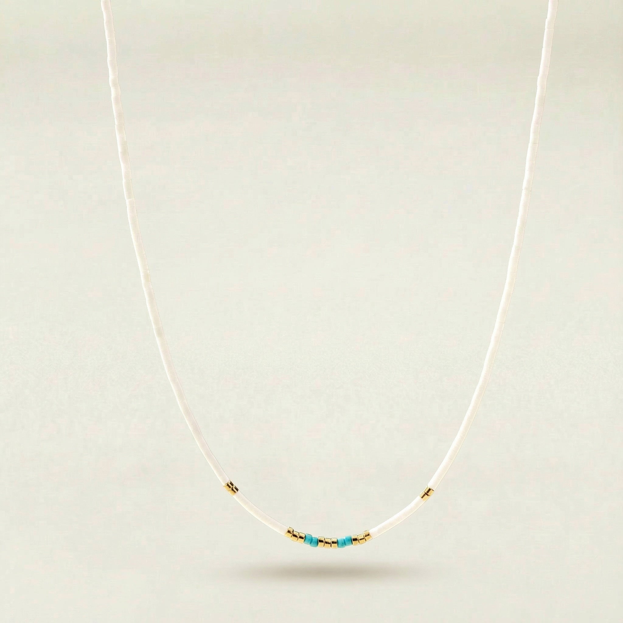 Necklace with turquoise beads on a white background