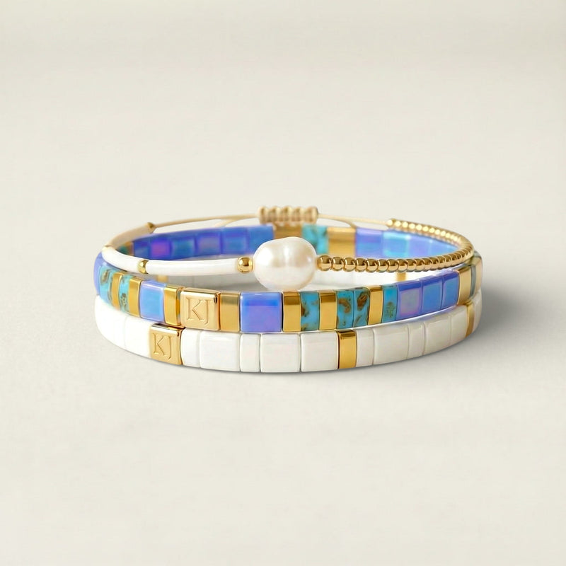 Stack of colorful bracelets on a beige background
